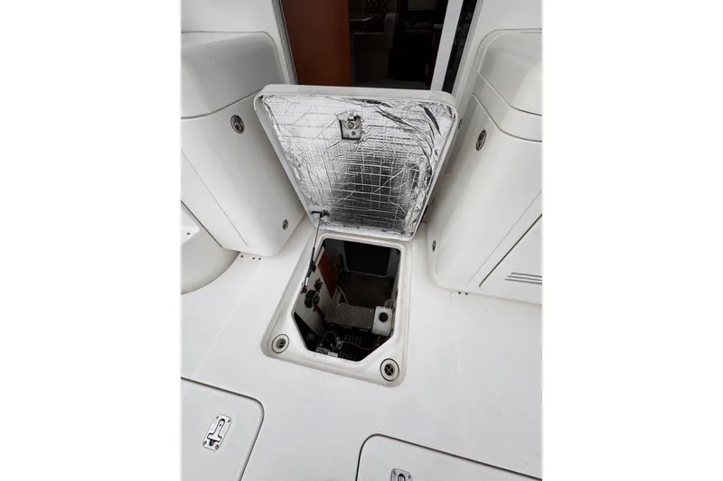 Slide: The Image of Open hatch on 2004 Silverton 38 Convertible boat deck, revealing interior compartment. - 43