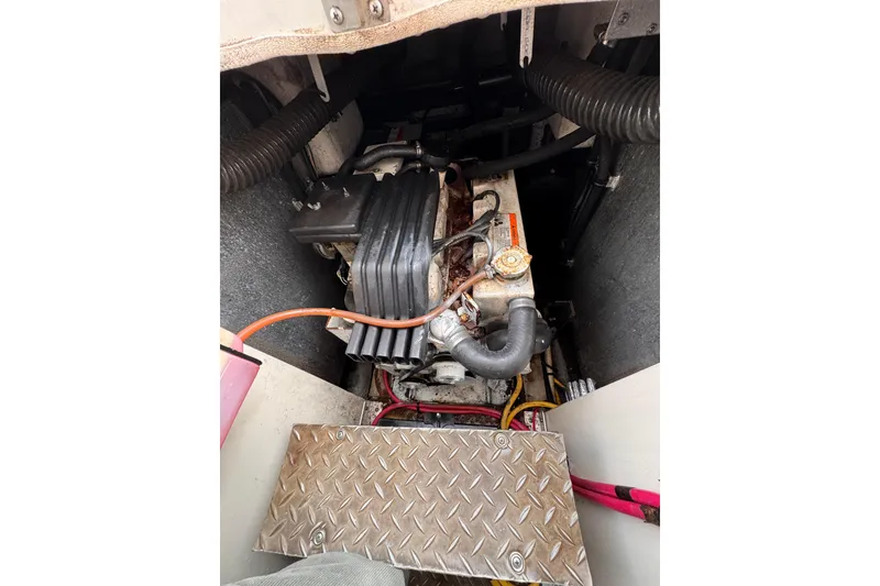 Slide: The Image of Engine compartment of a 2004 Silverton 38 Convertible boat, featuring visible components and wiring. - 44
