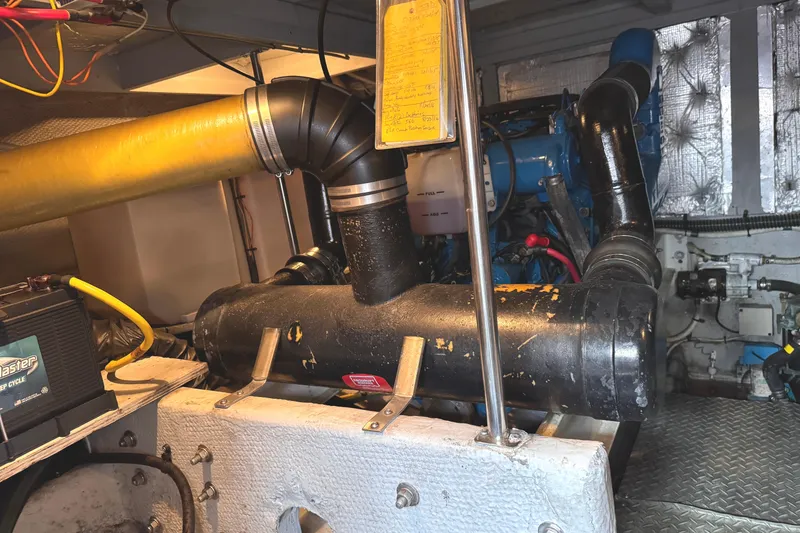 Slide: The Image of Engine room of a 2004 Silverton 38 Convertible boat, showcasing mechanical components. - 45