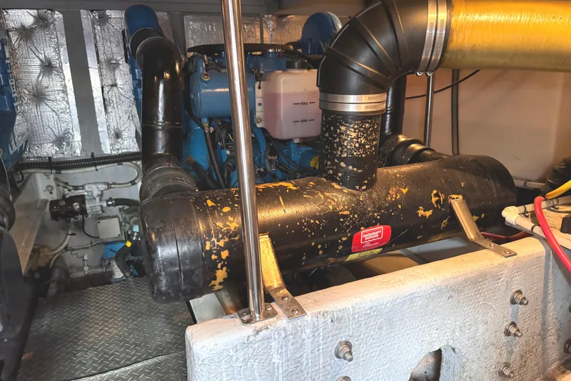 Slide: The Image of Engine room of a 2004 Silverton 38 Convertible boat, showcasing mechanical components. - 46
