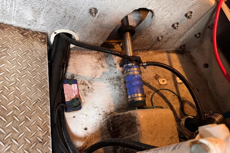 Slide: The Image of Engine compartment of a 2004 Silverton 38 Convertible boat, showing mechanical components and wiring. - 48
