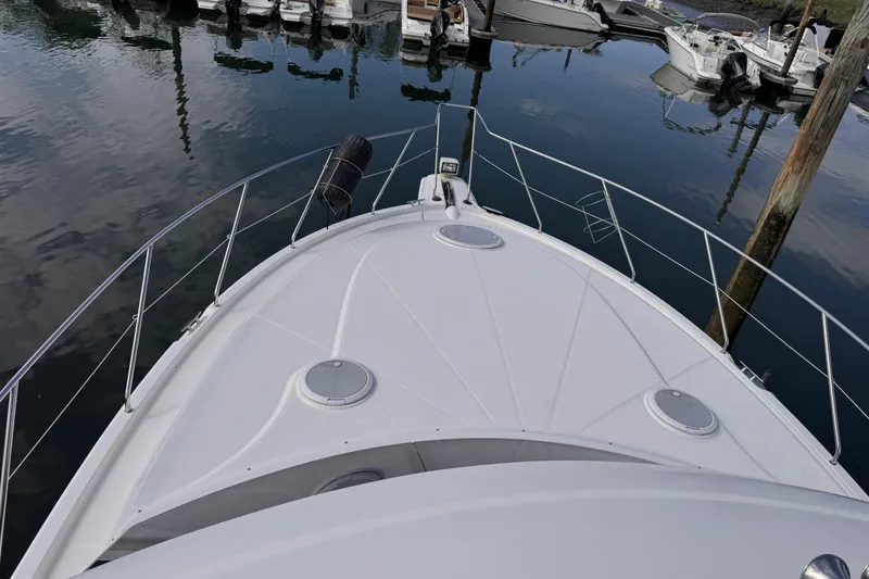 Slide: The Image of 2004 Silverton 38 Convertible yacht docked at marina, view from bow. - 51