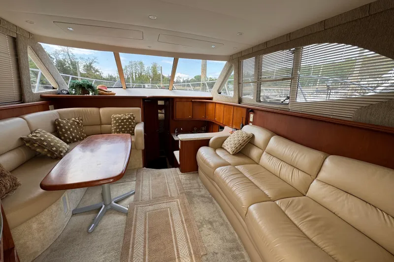 Slide: The Image of Luxurious interior of a 2004 Silverton 38 Convertible yacht with plush seating and elegant decor. - 9