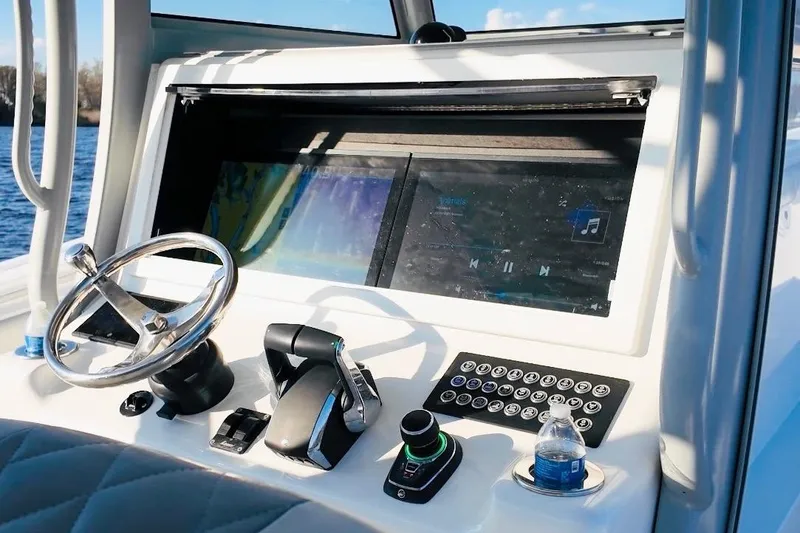 Slide: The Image of Helm of 2025 Onslow Bay 41 Tournament boat with modern controls and touchscreen display. - 14
