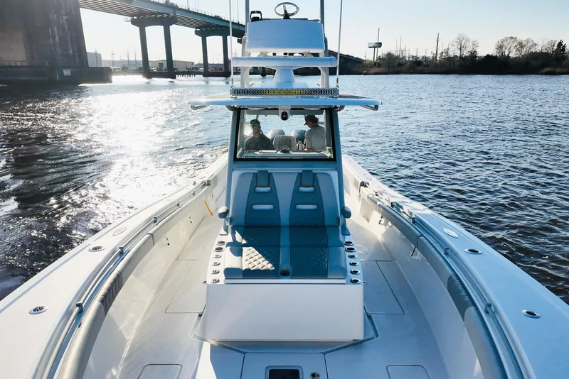 Slide: The Image of 2025 Onslow Bay 41 Tournament boat cruising under a bridge on a sunny day. - 17