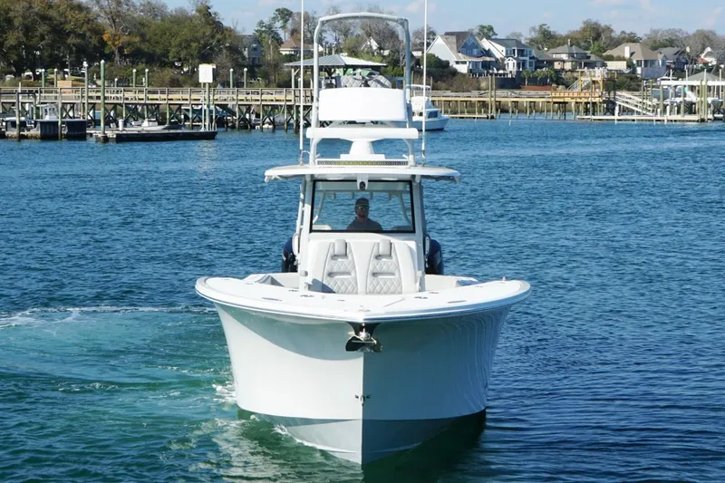 Slide: The Image of 2025 Onslow Bay 41 Tournament boat cruising in a scenic harbor setting. - 5