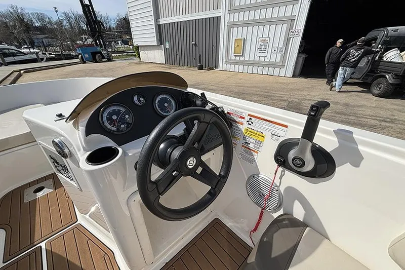 Slide: The Image of 2018 Bayliner Element E21 boat dashboard with steering wheel and controls. - 12