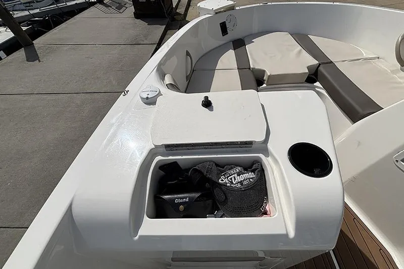 Slide: The Image of 2018 Bayliner Element E21 boat interior with seating and storage compartment. - 14