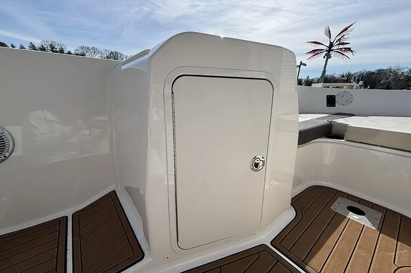 Slide: The Image of 2018 Bayliner Element E21 boat interior with storage compartment and seating. - 15
