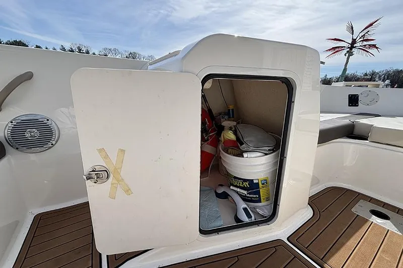Slide: The Image of 2018 Bayliner Element E21 boat storage compartment with supplies and equipment. - 16