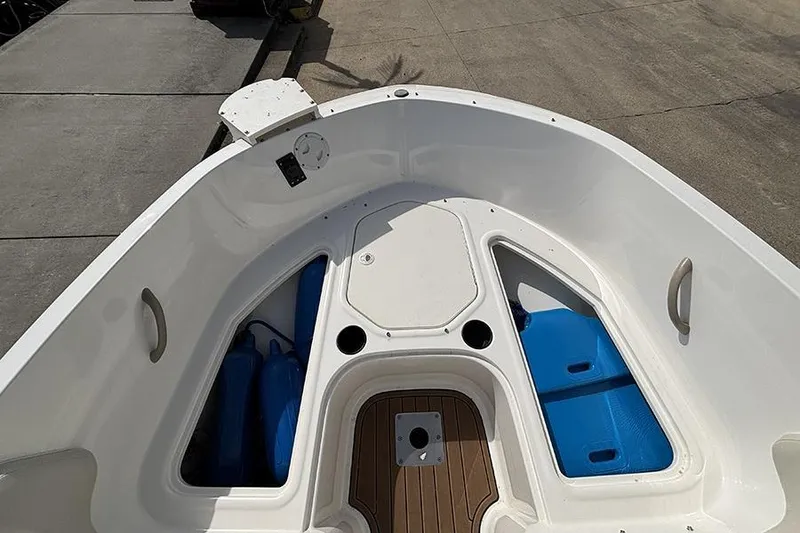 Slide: The Image of 2018 Bayliner Element E21 boat interior with storage compartments and seating area. - 18