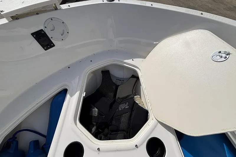 Slide: The Image of 2018 Bayliner Element E21 boat storage compartment with life jacket inside. - 19