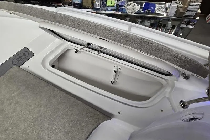 Slide: The Image of 2025 Sea Hunt BX 25 FS boat storage compartment, open lid, interior view. - 11