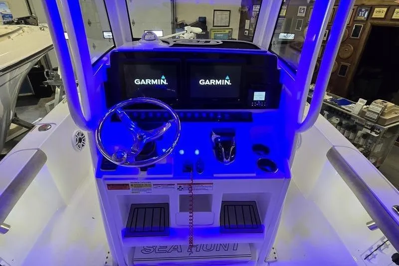 Slide: The Image of 2025 Sea Hunt BX 25 FS boat console with Garmin displays and illuminated controls. - 15