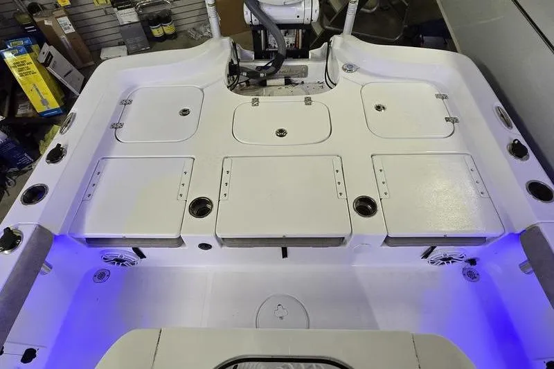 Slide: The Image of 2025 Sea Hunt BX 25 FS boat deck with storage compartments and blue LED lighting. - 17