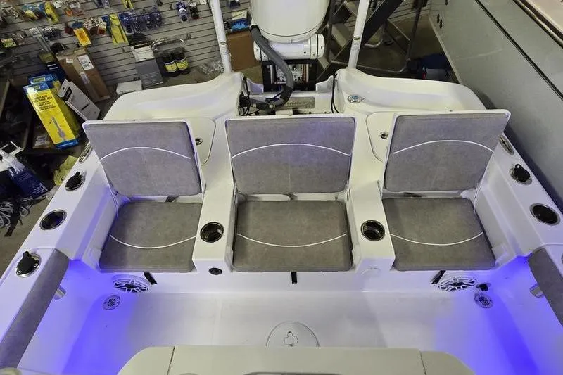 Slide: The Image of 2025 Sea Hunt BX 25 FS boat interior with gray seating and cup holders. - 18
