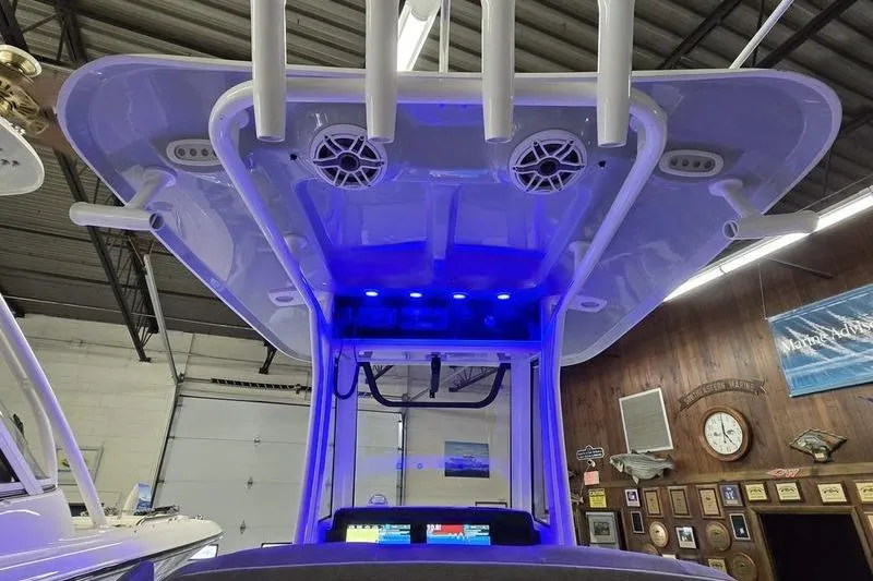Slide: The Image of 2025 Sea Hunt BX 25 FS boat with illuminated T-top and speakers in showroom. - 20