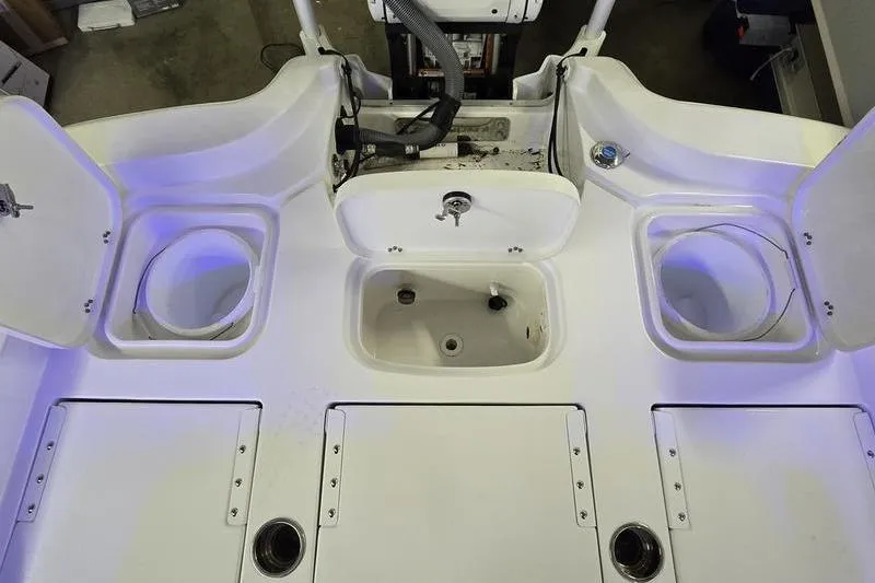 Slide: The Image of 2025 Sea Hunt BX 25 FS boat deck with storage compartments and livewells. - 3