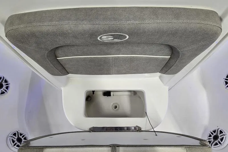 Slide: The Image of 2025 Sea Hunt BX 25 FS boat interior with cushioned seating and storage compartment. - 9