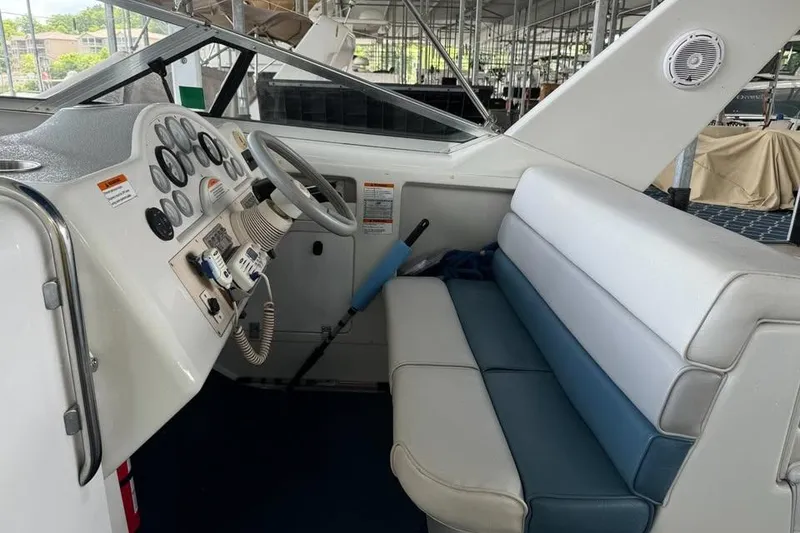 Slide: The Image of 1994 Chris-Craft 322 Crowne boat interior with steering wheel and seating area. - 3
