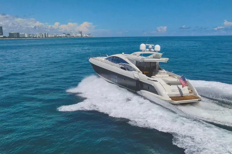 Slide: The Image of Luxurious 2011 Azimut 68S yacht cruising on open sea near city skyline. - 1