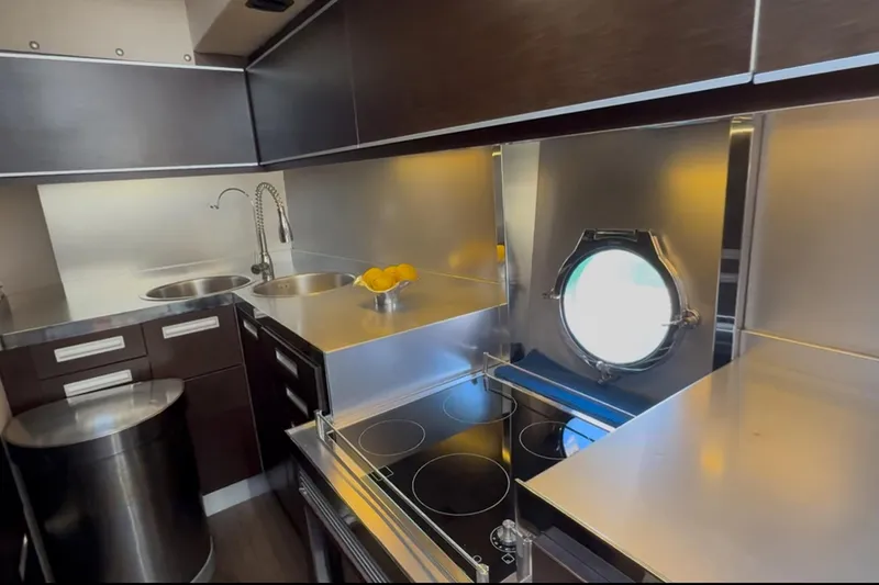 Slide: The Image of Modern kitchen interior of 2011 Azimut 68S yacht with sleek design and porthole window. - 18