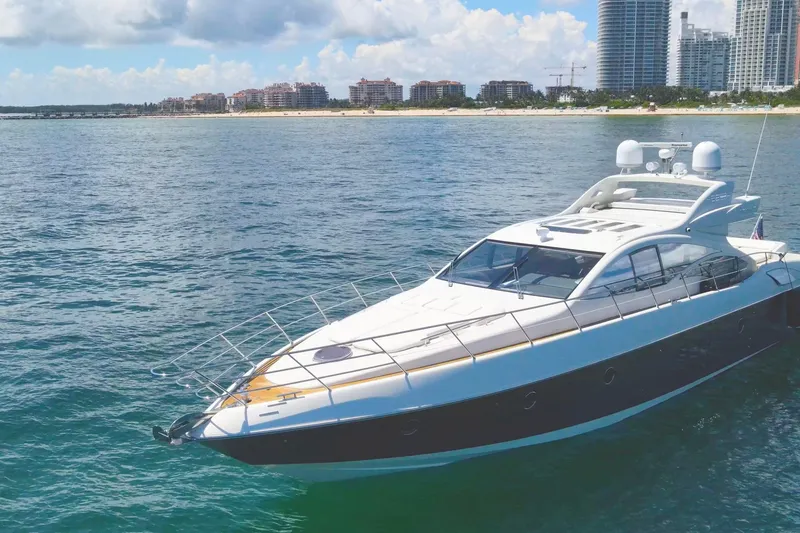 The Image of Luxury 2011 Azimut 68S yacht cruising near a coastal city skyline. - 2