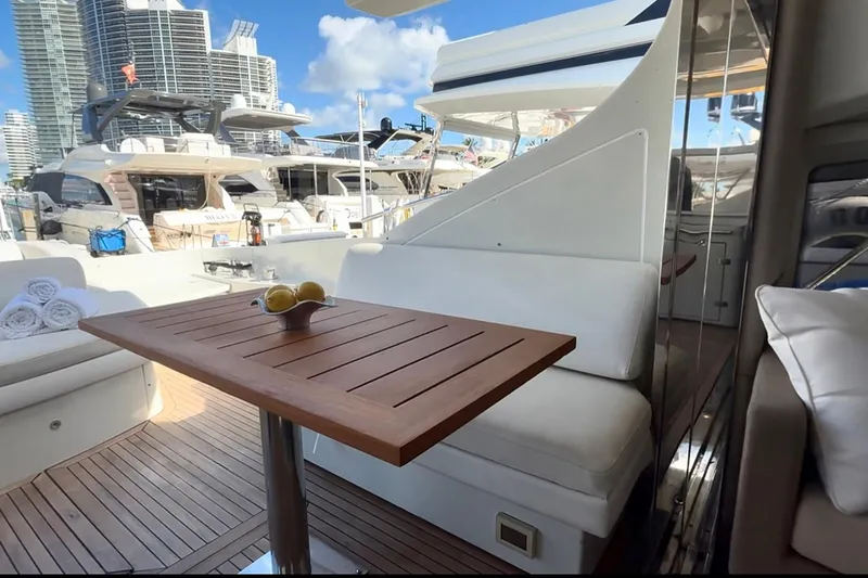 Slide: The Image of Luxurious Azimut 68S yacht deck with wooden table, docked in a marina. - 11