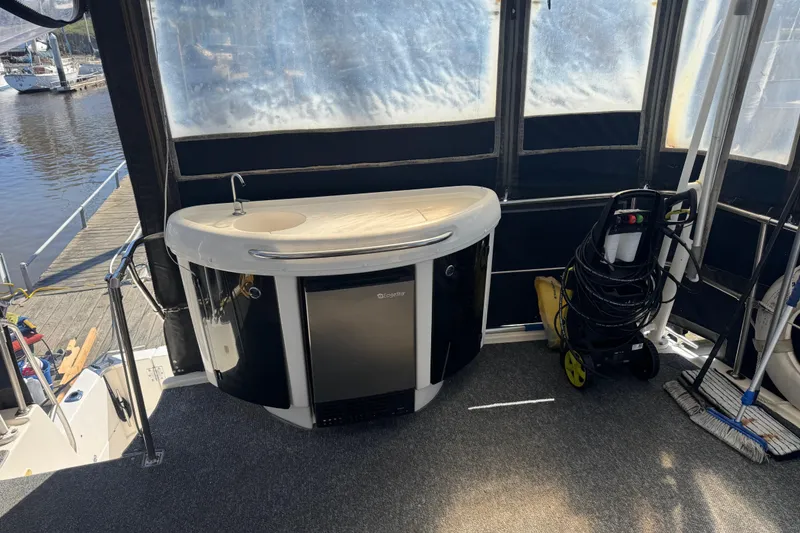 Slide: The Image of 1998 Bayliner 4087 Aft Cabin Motoryacht interior with mini bar and cleaning equipment. - 12