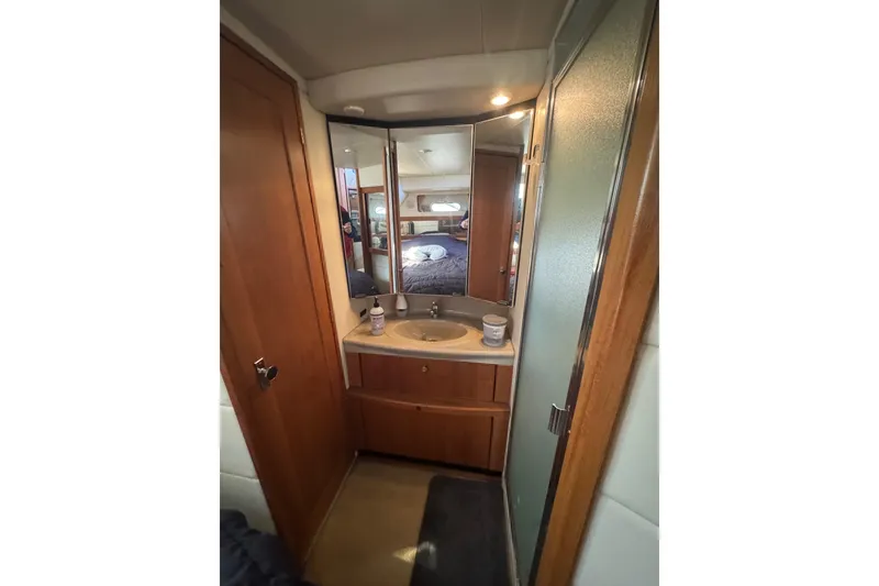 Slide: The Image of 1998 Bayliner 4087 Aft Cabin Motoryacht bathroom with sink, mirror, and shower. - 13
