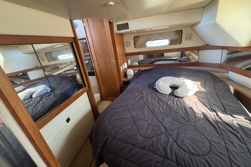 Slide: The Image of 1998 Bayliner 4087 Aft Cabin Motoryacht bedroom with cozy bed and wooden accents. - 14