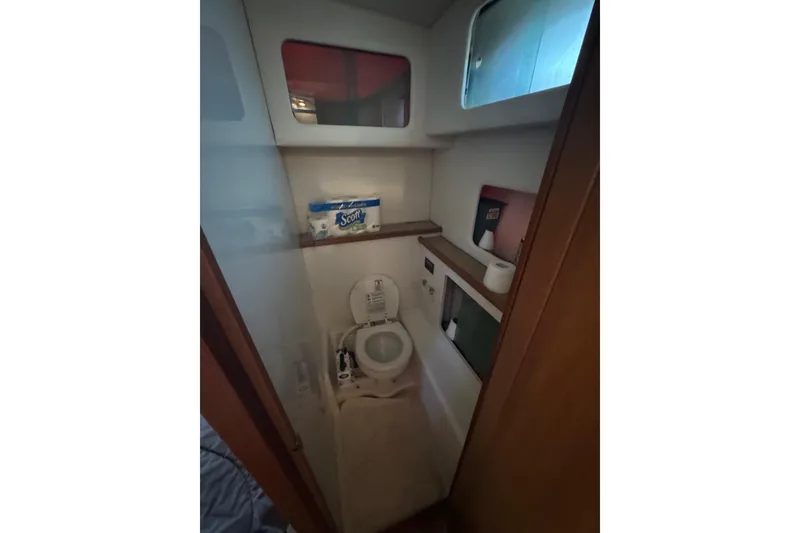 Slide: The Image of 1998 Bayliner 4087 Aft Cabin Motoryacht bathroom with toilet and storage shelves. - 18