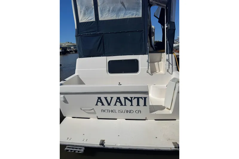 Slide: The Image of 1998 Bayliner 4087 Aft Cabin Motoryacht docked, featuring "Avanti" name and Bethel Island, CA location. - 2
