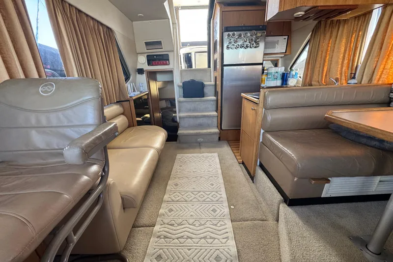 Slide: The Image of Interior of 1998 Bayliner 4087 Aft Cabin Motoryacht with seating, kitchenette, and stairs. - 22