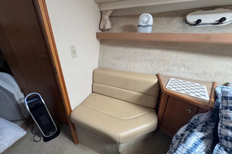 Slide: The Image of 1998 Bayliner 4087 Aft Cabin Motoryacht interior with seating, heater, and chessboard. - 29