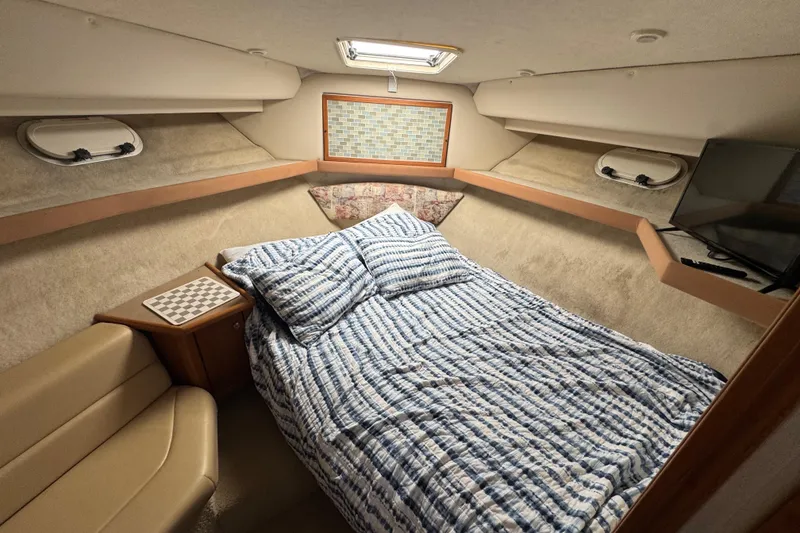 Slide: The Image of Cozy cabin interior of 1998 Bayliner 4087 Aft Cabin Motoryacht with bed and seating area. - 30