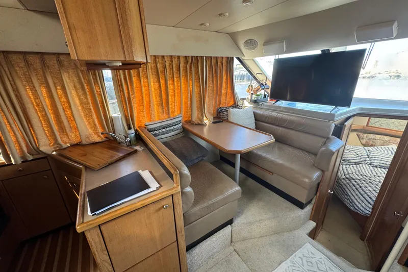 Slide: The Image of 1998 Bayliner 4087 Aft Cabin Motoryacht interior with cozy seating and large windows. - 32