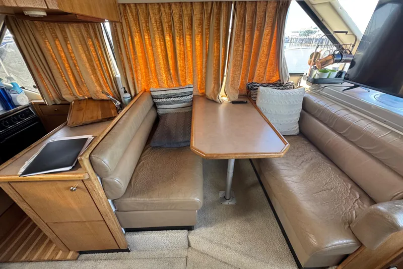 Slide: The Image of 1998 Bayliner 4087 Aft Cabin Motoryacht interior with cozy seating and dining area. - 34