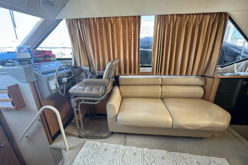 Slide: The Image of 1998 Bayliner 4087 Aft Cabin Motoryacht interior with helm, leather seating, and curtains. - 35