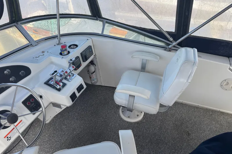Slide: The Image of 1998 Bayliner 4087 Aft Cabin Motoryacht helm with steering wheel and captain's chair. - 5