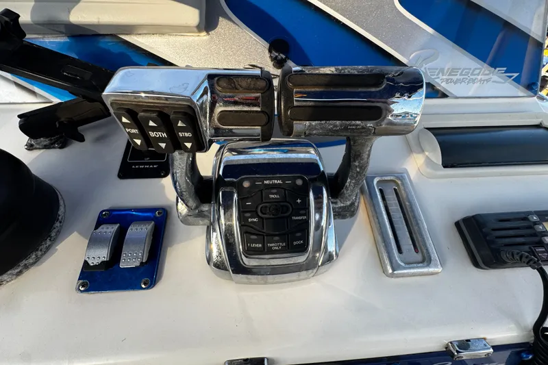 Slide: The Image of Control panel of 2012 Renegade 32 CC boat with throttle and switches. - 12