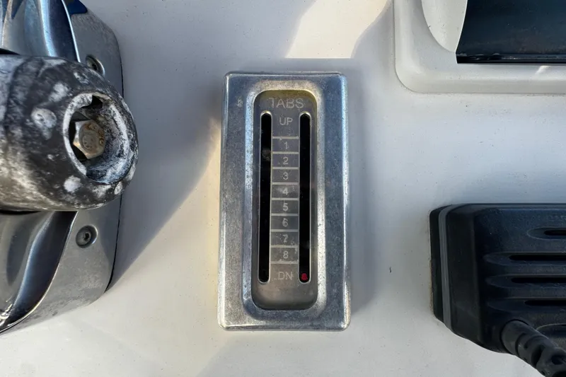 Slide: The Image of Close-up of a 2012 Renegade 32 CC boat control panel with trim indicator. - 16