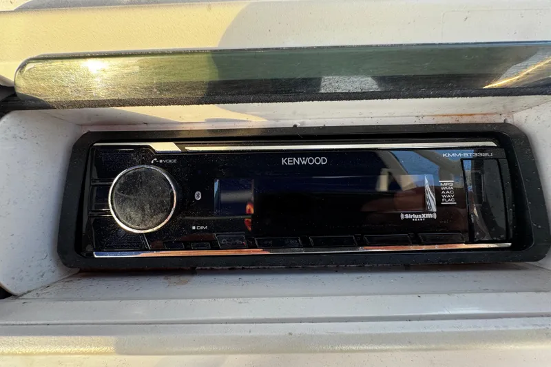Slide: The Image of Kenwood stereo system in a 2012 Renegade 32 CC boat dashboard. - 18