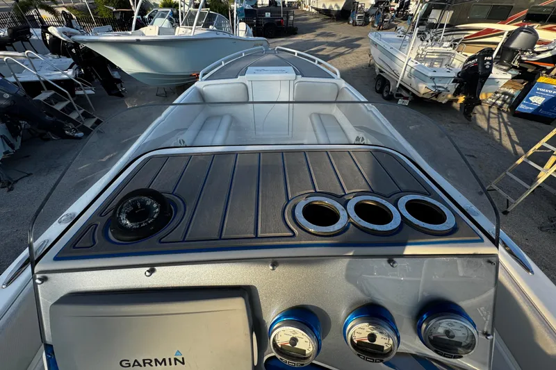 Slide: The Image of 2012 Renegade 32 CC boat dashboard with Garmin navigation and gauges. - 20