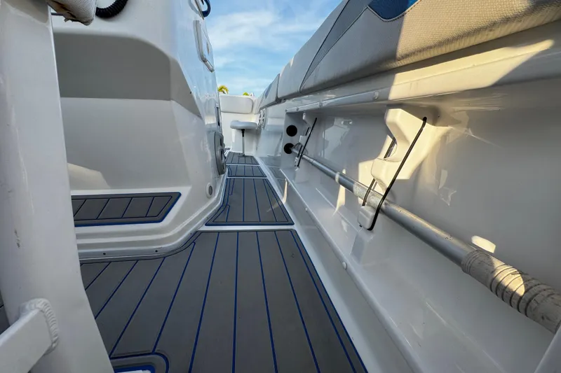 Slide: The Image of 2012 Renegade 32 CC boat interior with sleek flooring and rod holders. - 22
