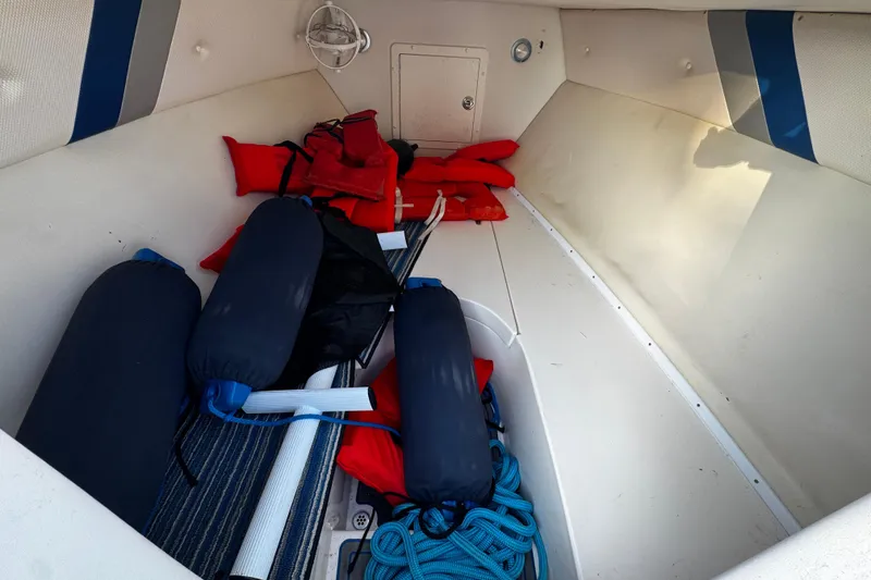 Slide: The Image of Interior of 2012 Renegade 32 CC boat with life jackets and fenders. - 30
