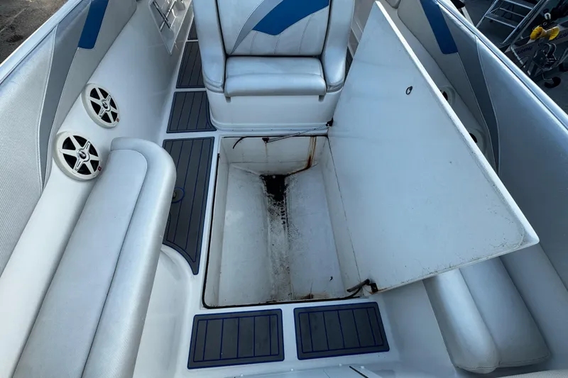 Slide: The Image of 2012 Renegade 32 CC boat interior with seating and storage compartments. - 31