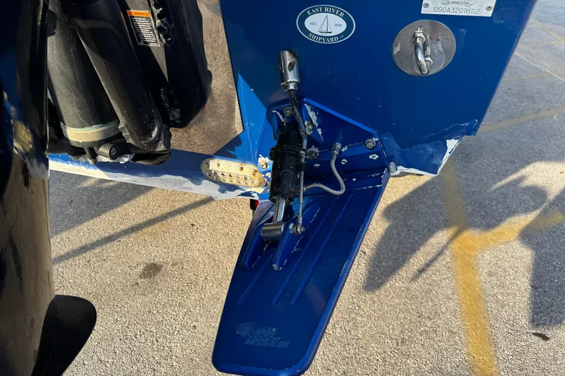 Slide: The Image of 2012 Renegade 32 CC boat detail showing trim tab and hydraulic system. - 36