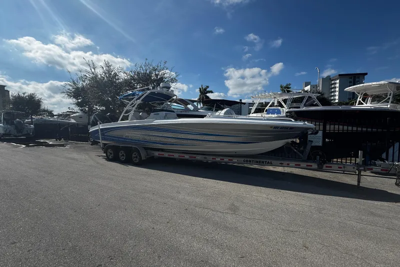 Slide: The Image of 2012 Renegade 32 CC boat on trailer under clear blue sky. - 39
