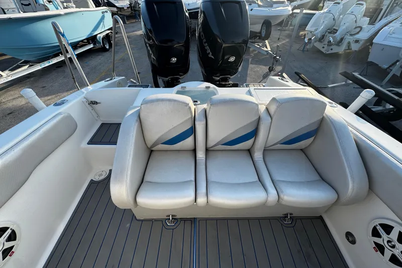 Slide: The Image of 2012 Renegade 32 CC boat interior with triple seating and dual outboard motors. - 5